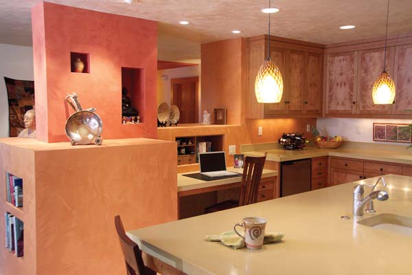 
The open kitchen allows space for a small work area. Built-in shelves and nooks provide neat, natural storage and display areas.
